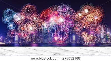 Happy New Year Fireworks Over Cityscape At Night With Empty White Marlbe Table,banner Mock Up Templa