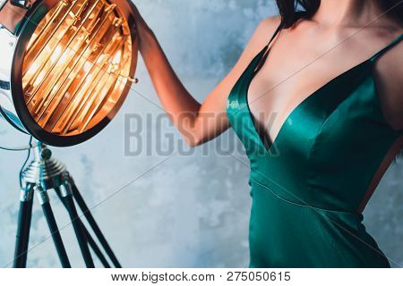 Neckline, Beautiful Large Female Breast, Green Dress, Close-up. Aluminum Cinema Spotlight