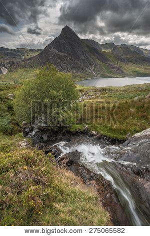 Beautiful Landscape Image Of Stream Near Llyn Ogwen In Snowdonia During Early Autumn Flowing Towards