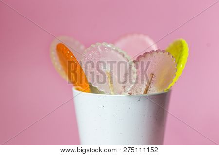 Multi-colored Lollipops On A Pink Background With Decoration