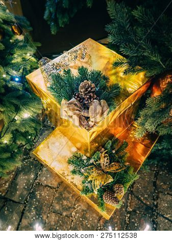 Christmas Still Life From The Scenery Of Gifts Under The Tree With Luminous Garlands. Golden Gifts U