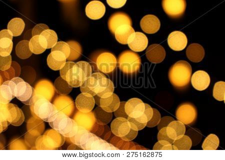 Abstract Blurred And Bokeh Of Reflection Lighting Of Light Bubs On Black Background.