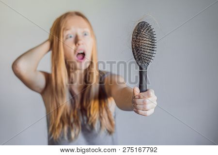 Hair Loss In Women Concept. A Lot Of Lost Hair On The Comb