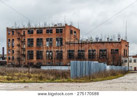 Abandoned Red Brick Factory Building With Glassless Windows