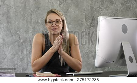 Cute Businesswoman Looks At The Camera And Talks In Her Office.