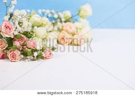 Border From Fresh White Gypsofila And White Rose Flowers Against Blue Textured Background.  Place Fo