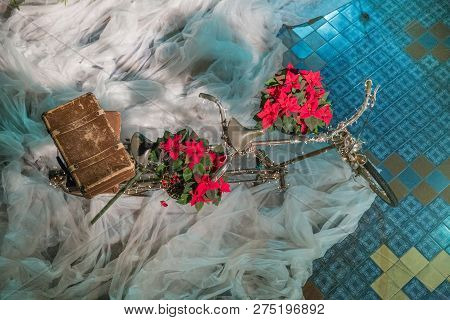 Old Retro Tandem Bicycle And Christmas Decors, Red Flowers. Travel Photo 2018. December.