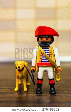 Poznan, Poland - December 22, 2018: Playmobil Toy Pirate Walking Her Dog Out With A Line In Soft Foc
