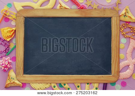 Purim Celebration Concept (jewish Carnival Holiday) Over Purple, Pink Wooden Background. Top View