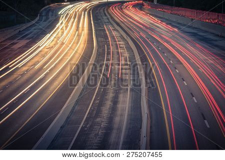 Filtered Image Of Colorful Highway Car Light Trails At Evening In Texas, America