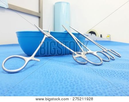 Blue Kidney Tray With Kocher Forceps On The Table