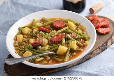 Italian soup minestrone with fuet sausage