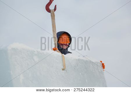 Portrait Of A Fitter Slinger In A Jacket And Helmet On The Unloading Of Ice Plates