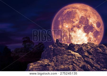 Dark Purple Moon Back Over Stone Monster On Rock Of Cliff
