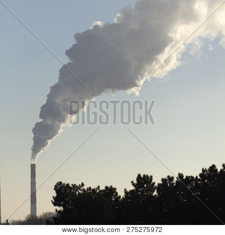 Smoke From Industrial Chimneys Against The Blue Sky. Pollution.