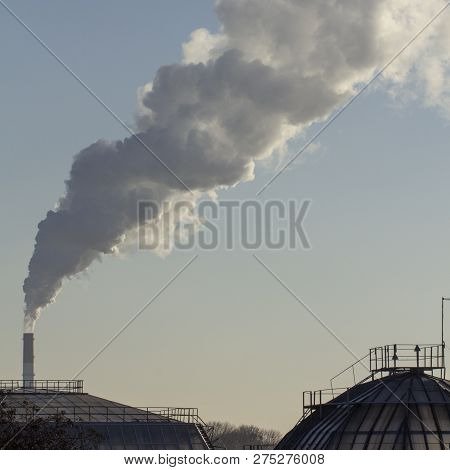 Smoke From Industrial Chimneys Against The Blue Sky. Pollution.