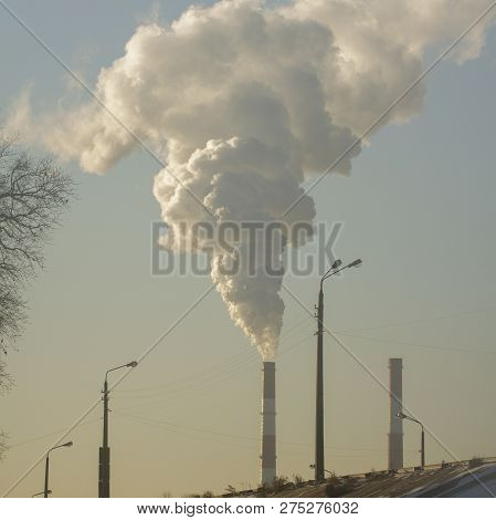 Smoke From Industrial Chimneys Against The Blue Sky. Pollution.