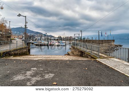 New Harbor Of Luino On The Lake Maggiore In Cloudy Day, Province Of Varese, Italy