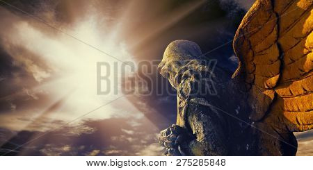 Antique Statue Of A Guardian Angel In Sunlight.