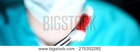 Surgeon In Sterile Uniform Arms Holding And Passing To Colleague Tools With Bio Material Wad Closeup
