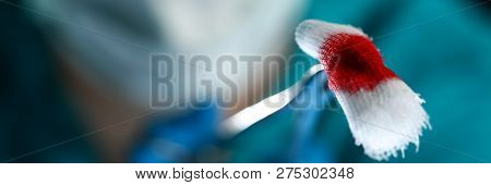 Surgeon In Sterile Uniform Arms Holding And Passing To Colleague Tools With Bio Material Wad Closeup