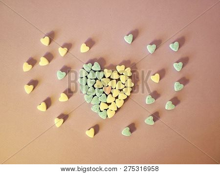 Heart From Small Hearts Tablets, Sweet Vitamins On Tinted Paper, Top View, Concept Of Love, Health, 