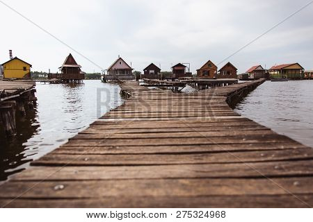 Wooden Bridges On The Lake Bokod. Fishing Wooden Cottages, Hungary