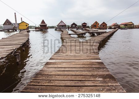 Wooden Bridges On The Lake Bokod. Fishing Wooden Cottages, Hungary