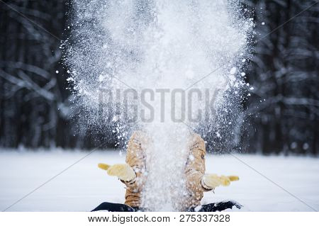 Very Beautiful Bright Young Girl In A Red Hat And Yellow Mittens On The Background Of A Winter Park