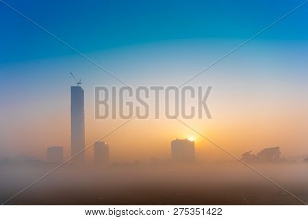 Beautiful Image Of Sunrise At Kolkata Maidan In A Foggy Winter Morning. Sunrises At The Horizon Abov