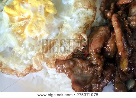 Fried Pork With Garlic Pepper On Rice And Fried Egg Close Up (selective Focus) Thai Menu Easy Street