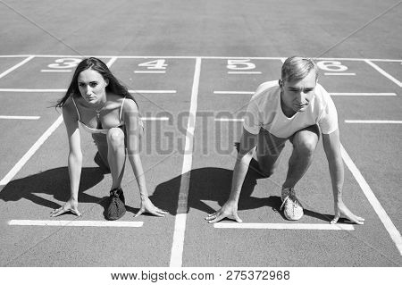 Equal Forces Concept. Man And Woman Low Start Position Running Surface Stadium. Running Competition 