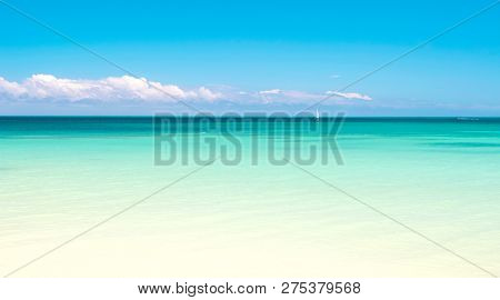 Sea. Beautiful White Clouds On Blue Sky Over Calm Sea With Sunlight Reflection, Bali . Tranquil Sea 