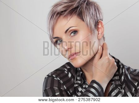 Portrait Of A Beautiful Blonde Woman With Beautiful Make-up And Short Haircut After Dyeing Hair In A