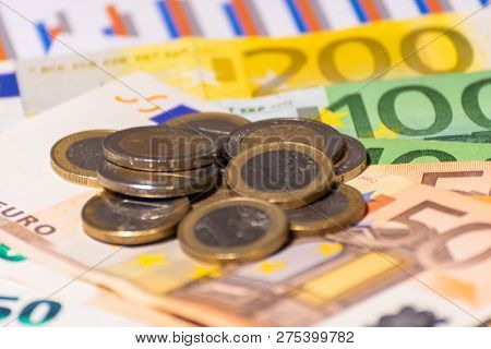 Financial Report, Coins And Euro Notes. Bills And Money. Many Euro Banknotes And Stacked Coins