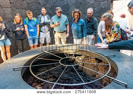 Lanzarote, Spain - Dec 13, 2018: People Watching On Barbecue With Volcanic Heat In Restaurant At Tim