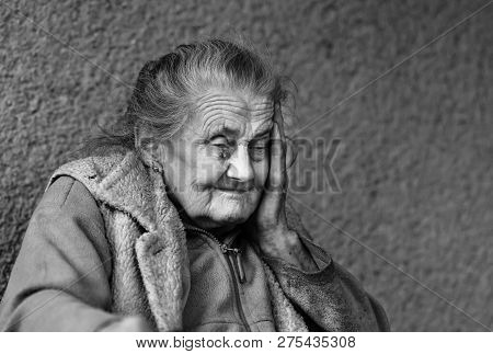 Very Old And Tired Wrinkled Woman Outdoors