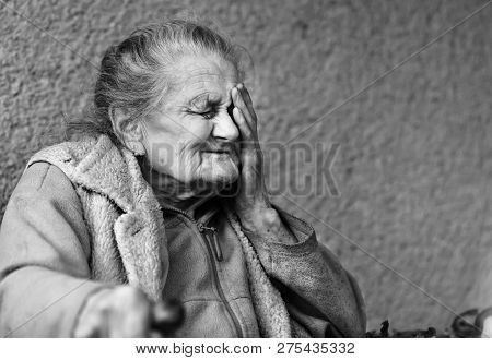 Very Old And Tired Wrinkled Woman Outdoors