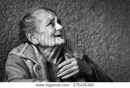 Very Old And Tired Wrinkled Woman Outdoors