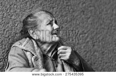 Very Old And Tired Wrinkled Woman Outdoors