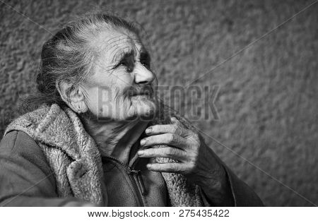 Very Old And Tired Wrinkled Woman Outdoors