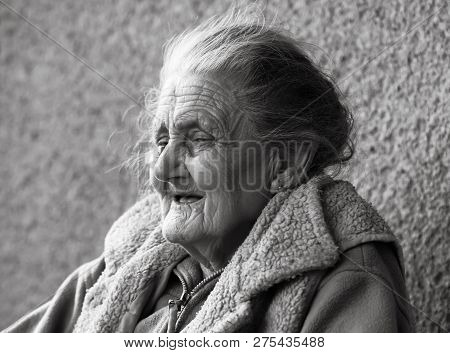 Very Old And Tired Wrinkled Woman Outdoors
