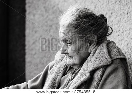 Very Old And Tired Wrinkled Woman Outdoors