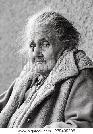 Very Old And Tired Wrinkled Woman Outdoors