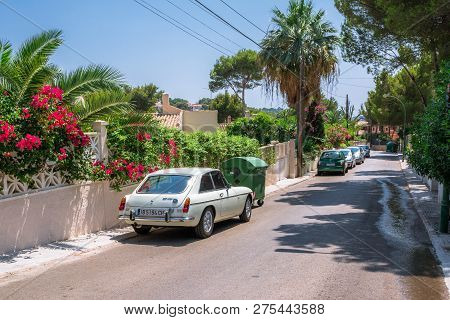 Santa Ponsa, Mallorca, Spain - July 24, 2013:  Retro Car Mg Bgt Is Parked Near A Wall With Flowers A