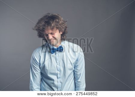 Portrait Of Unhappy Hophead Man Standing And Looking Aside With Melancholy. Isolated On Grey Backgro