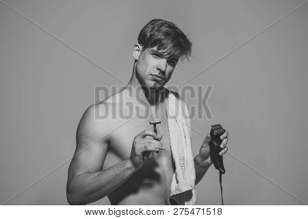 New Technology, Future, Innovation, Archaism. Man Choose Safety Or Electric Razor On Grey Background