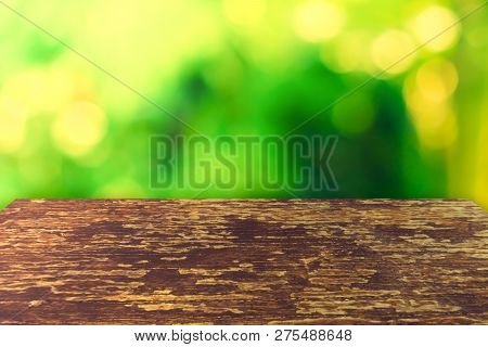 Selective Focus Of Empty Old Wood On Blur Nature Green Leaf With Bokeh.