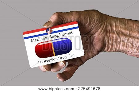 An Elderly Hand Holds A Medicare Supplement Insurance Id Card.