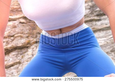 Flat Belly Girl During Diaphragmatic Breathing Exercises Bodyflex On The Rock Background. Belly Clos